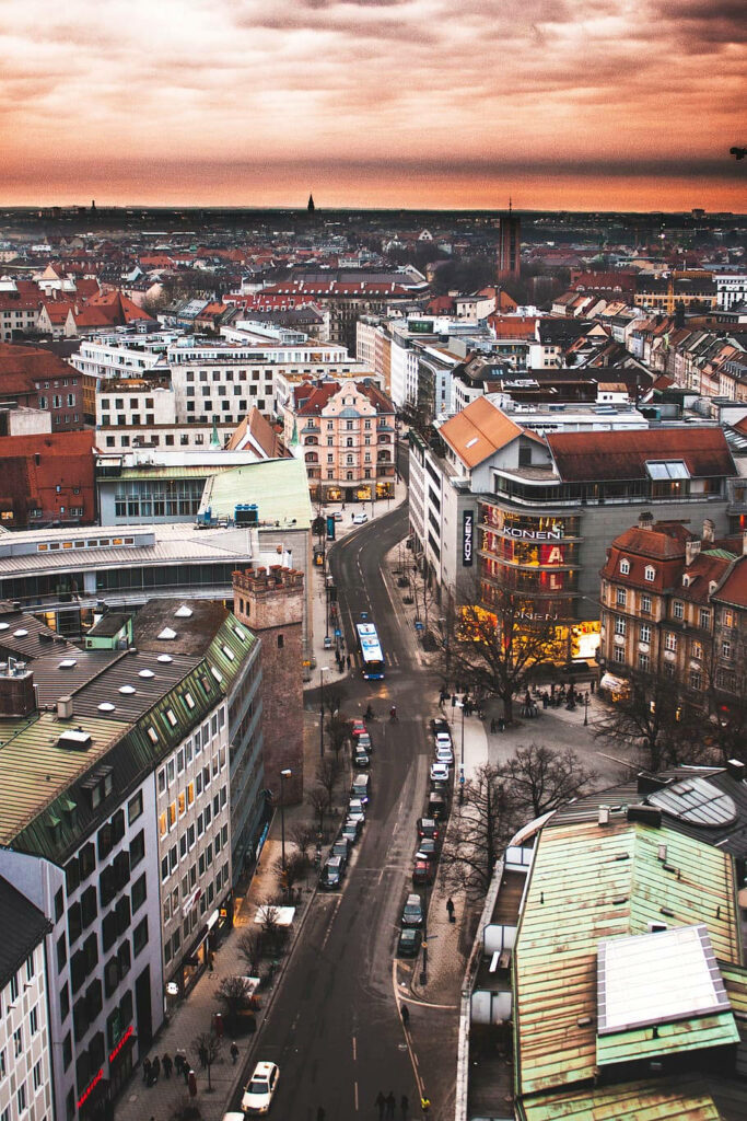 Aerial view of vibrant Munich street at sunset blending historic and modern architecture wallpaper