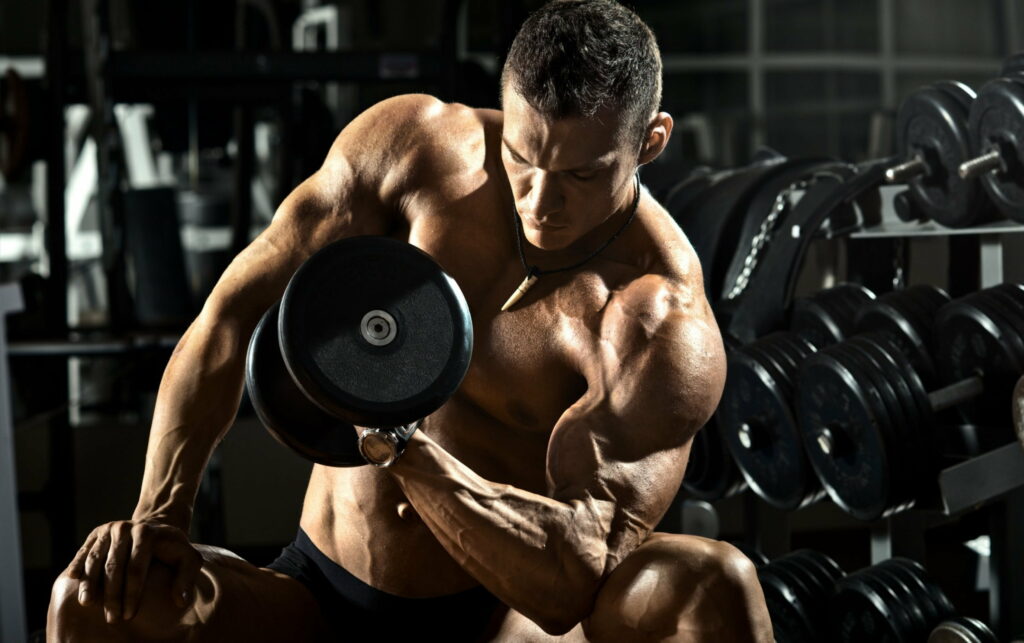 Powerful Physique: Exquisite QHD Wallpaper Featuring a Muscular Black Male Bodybuilder in a Fitness Gym Setting