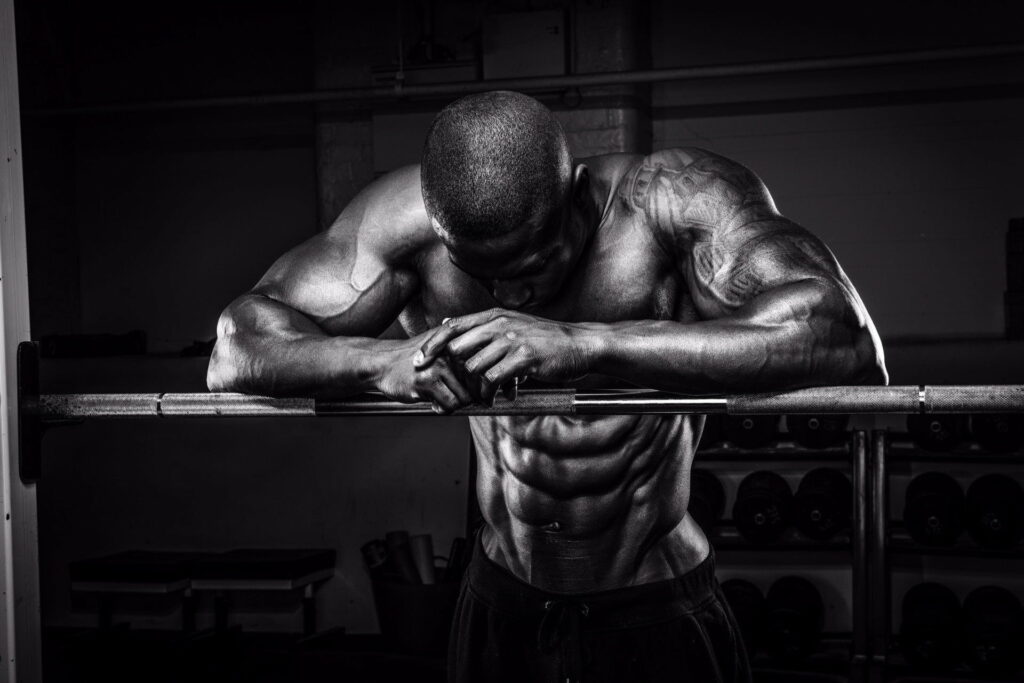 Muscle-Bound Athlete Pumping Iron: Spectacular HD Wallpaper for Sport and Training Enthusiasts
