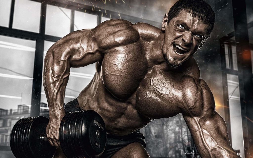 Muscular bodybuilder doing one-arm dumbbell row in dramatic gym lighting intense workout wallpaper