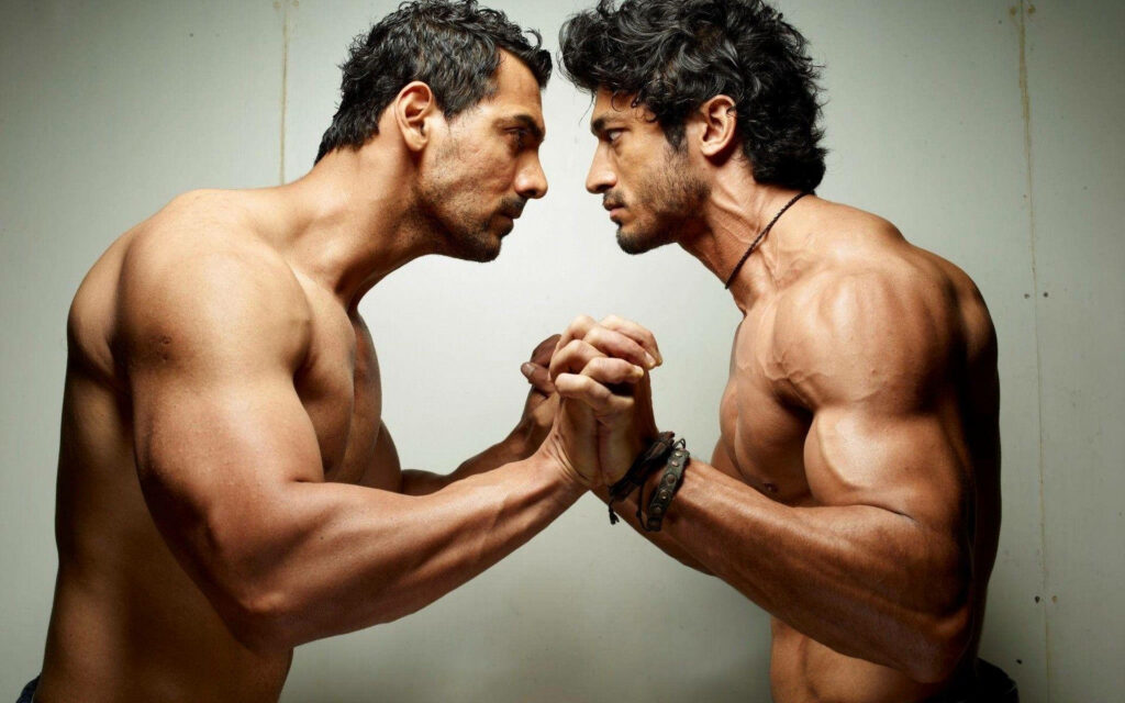 Two muscular men arm wrestling showing strength determination and competitive spirit wallpaper