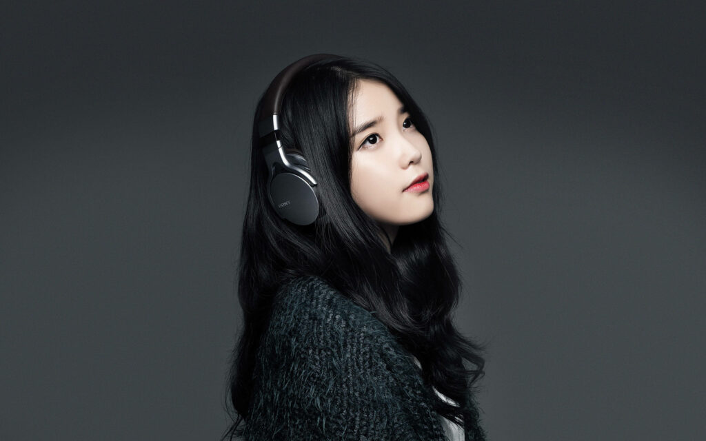 Melodic Style: IU Rocks Black Headphones & Fur in Striking Wallpaper Image