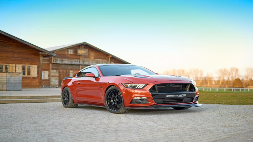 Mustang Geiger Ford GT 820 in 4K Ultra HD parked by rustic wooden building under clear sky wallpaper