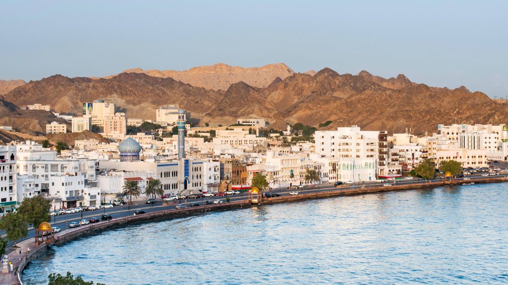 Mutrah Corniche Muscat Oman 4K cityscape blue dome mosque coastal road sunlit mountains Wallpaper