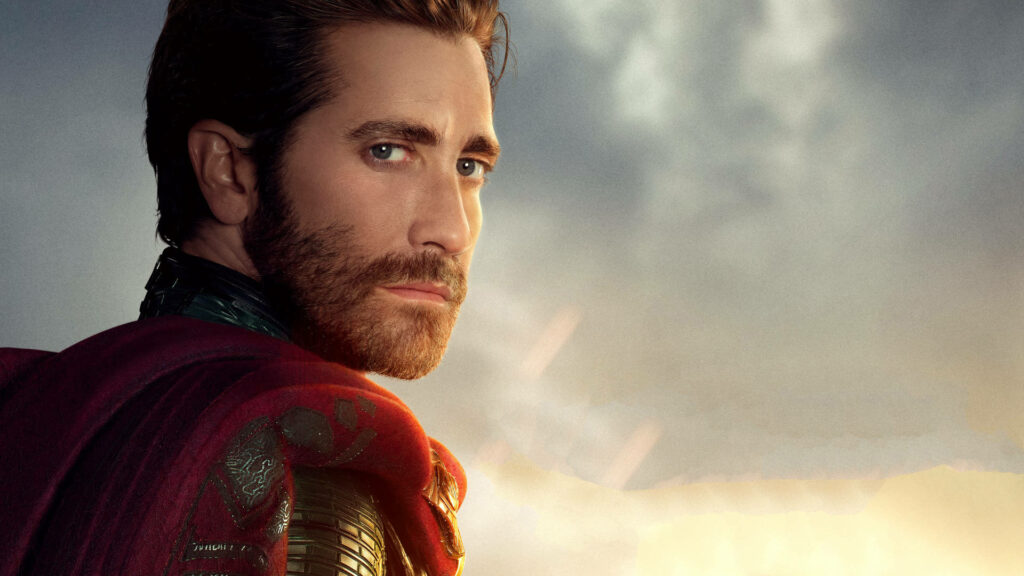 Jake Gyllenhaal as Mysterio in superhero costume gazing intensely with dramatic cloudy sky background Wallpaper