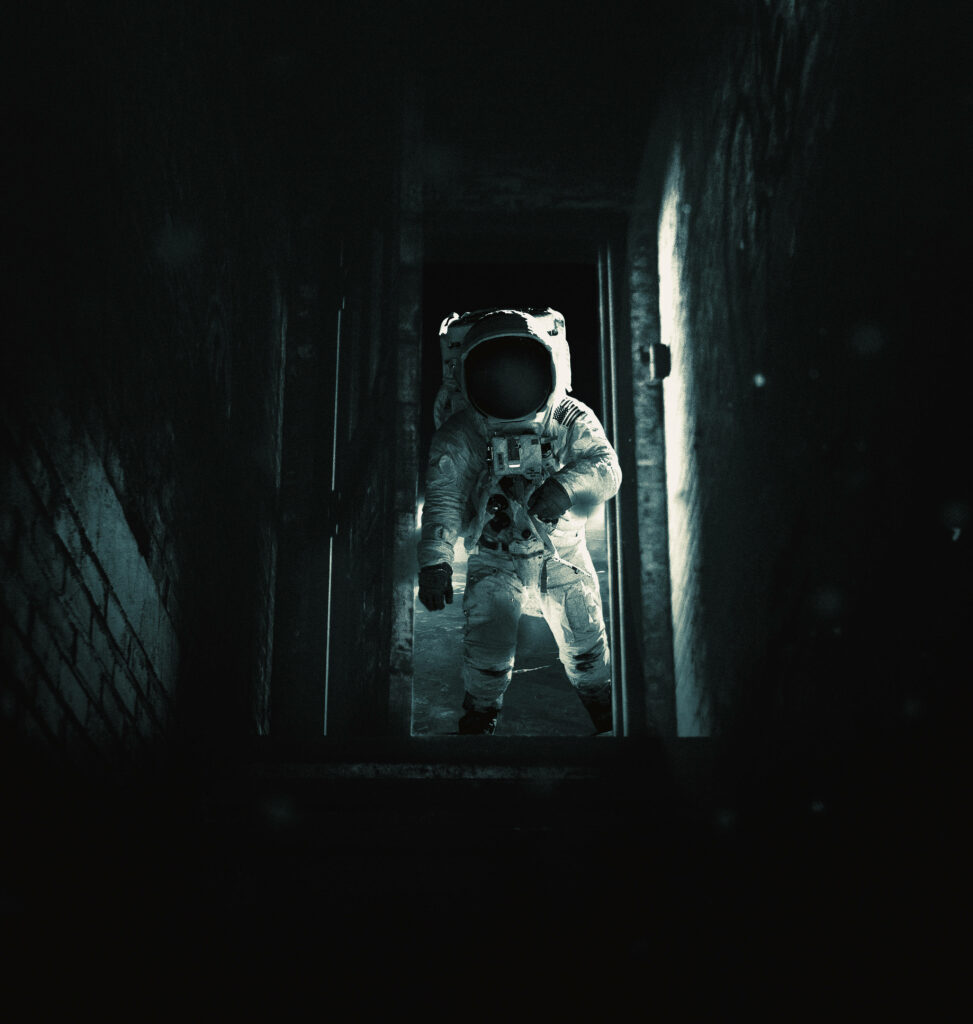 Mysterious Astronaut Wallpaper: Dimly Lit Corridor Exploration