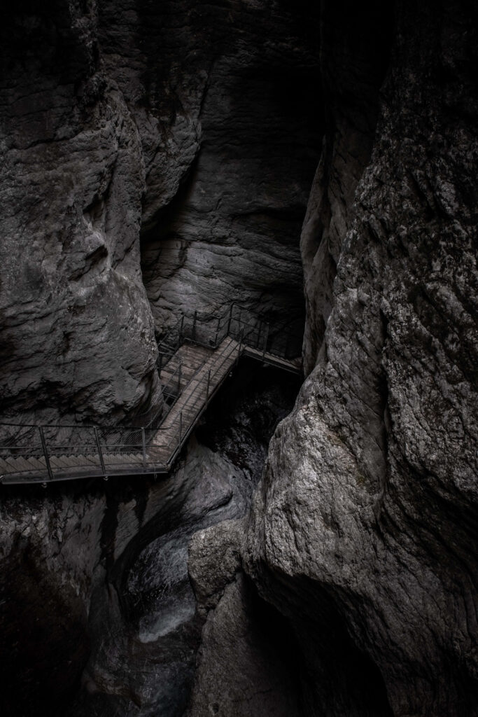 Mysterious Canyon Walkway: Adventure Through Towering Rock Walls Wallpaper