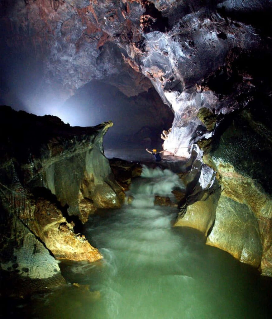 Ethereal Cave Wallpaper: Enchanting Stream & Rugged Rock Formations