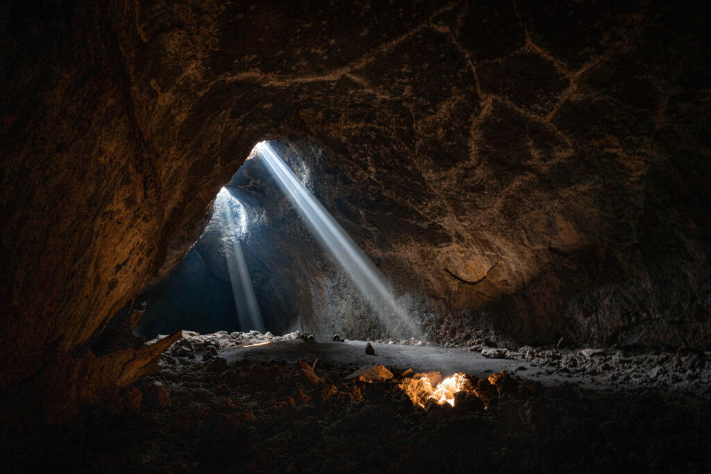 Mysterious Cave Wallpaper: Sunlit Illumination & Warm Fire Glow