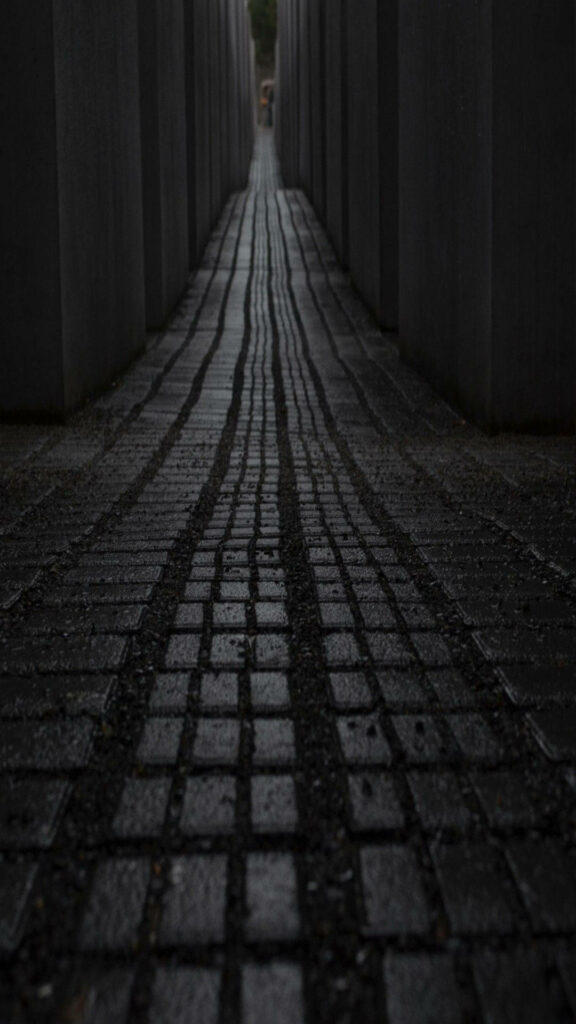 Mystical Cobblestone Pathway: Dark Concrete Walls & Distant Light Wallpaper