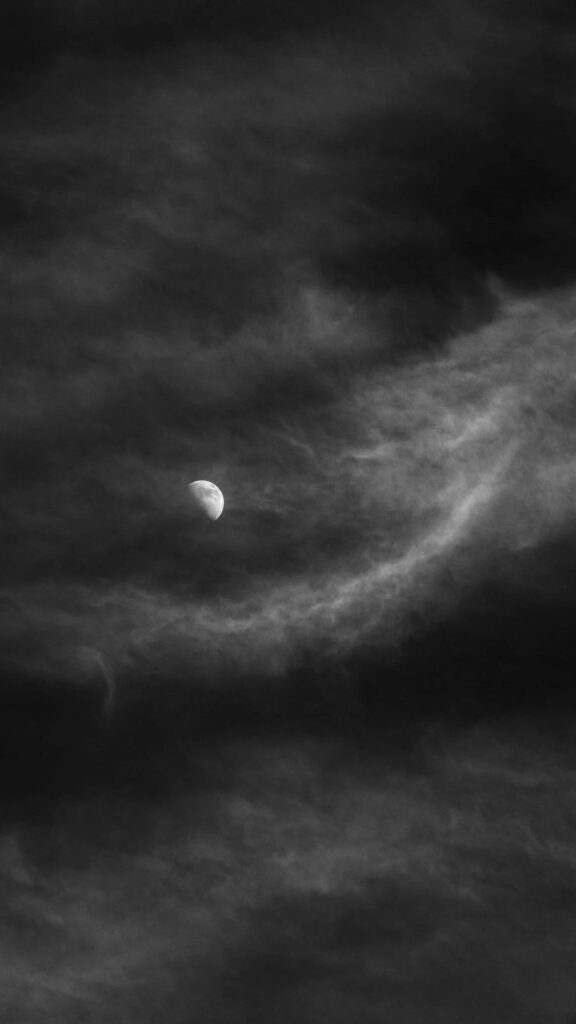 Mysterious Dark Moon Wallpaper: Enigmatic Swirling Clouds Background