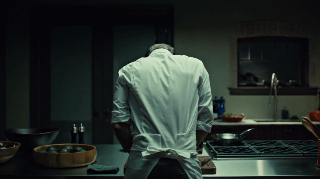 Mysterious Chef in Dimly Lit Kitchen - Wallpaper Background