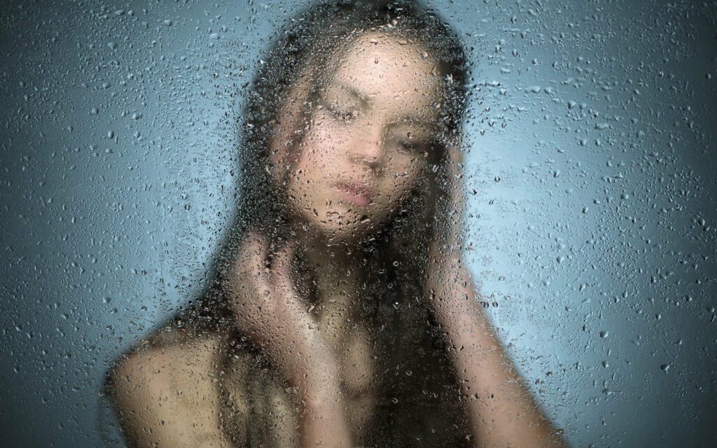 Mysterious Wet Silhouette: Seductive Black Hair Revealed through Blurred Frost Glass Wallpaper