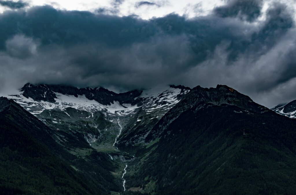 Dramatic Italian Alps wallpaper with rugged snow-capped peaks and foggy moody mountain landscape