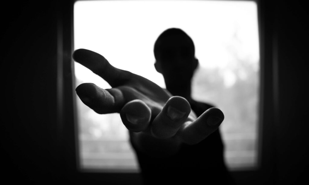 Silhouette Reaching: Mysterious Wallpaper with Blurred Background