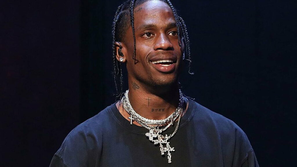Travis Scott's Energetic Presence Amidst a Dark Canvas: Captivating HD Wallpaper
