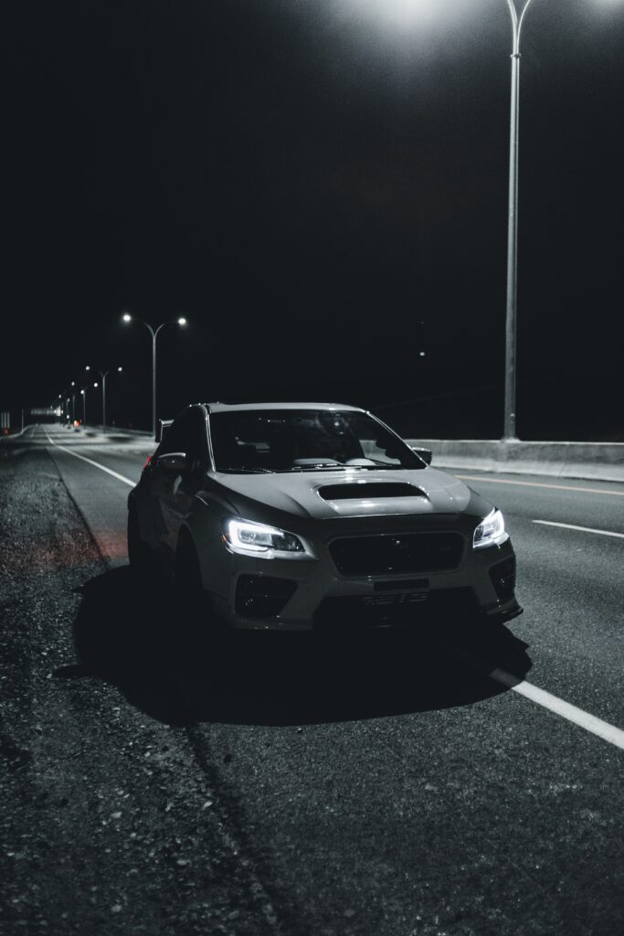 Moody Night Car Wallpaper: Parked on a Dimly Lit Road