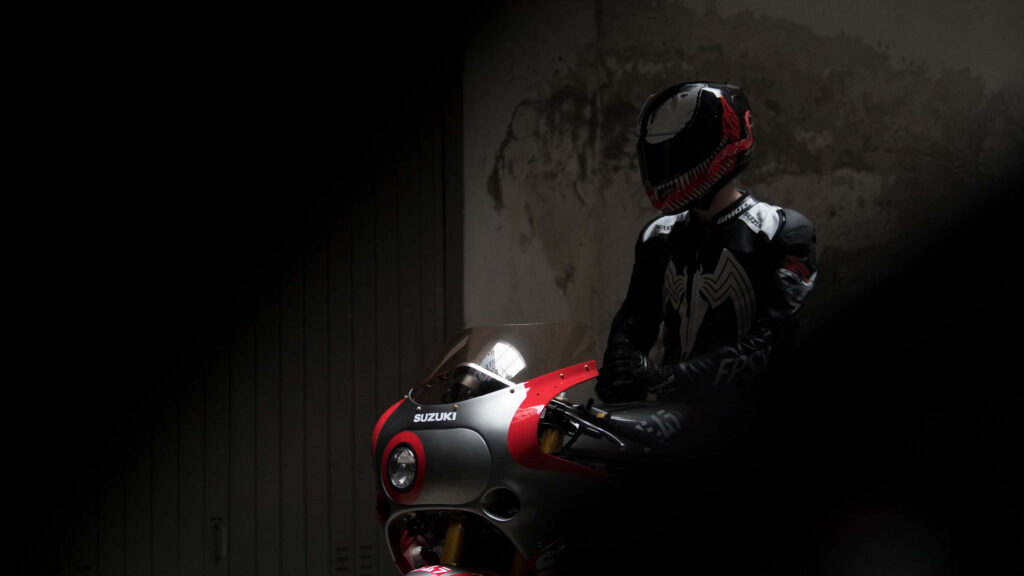 Mysterious Rider on Red Suzuki Motorcycle - Edgy Wallpaper Background