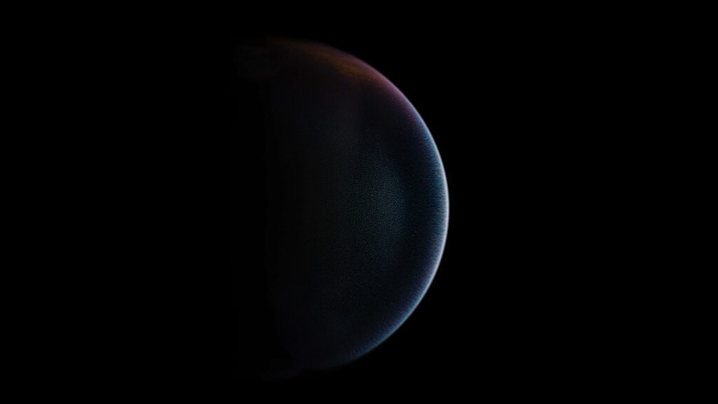 Mysterious spherical object in black space wallpaper, evoking cosmic curiosity and minimalist design for unique backgrounds.