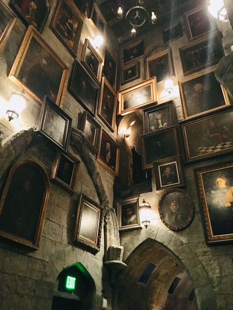 Mystical Stone-Walled Hallway Wallpaper with Enchanted Portraits