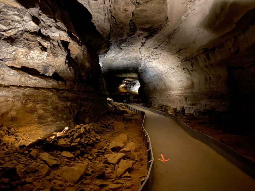 Discover Mysterious Underground Cave with Rugged Formations & Winding Path Wallpaper