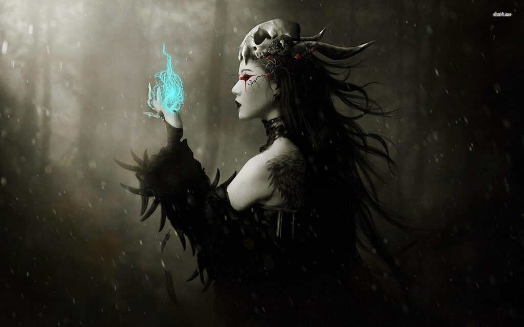 Mysterious witch with black feathers conjuring glowing blue orb in dark misty forest wallpaper background