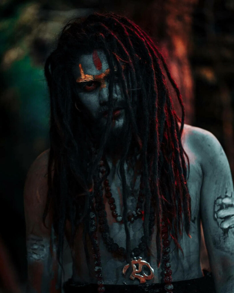 Aghori devotee portrait with dreadlocks sacred ash intense makeup spiritual wallpaper background