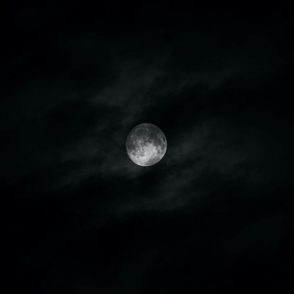 Mystical Dark Moon Wallpaper: Enigmatic Cloudy Night Sky Background