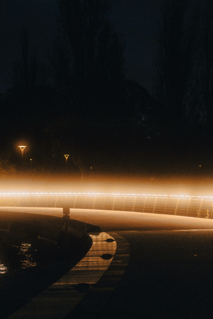 Enthralling Glow: Capturing the Radiance of Brown Lights Along the Serene Pathway Wallpaper