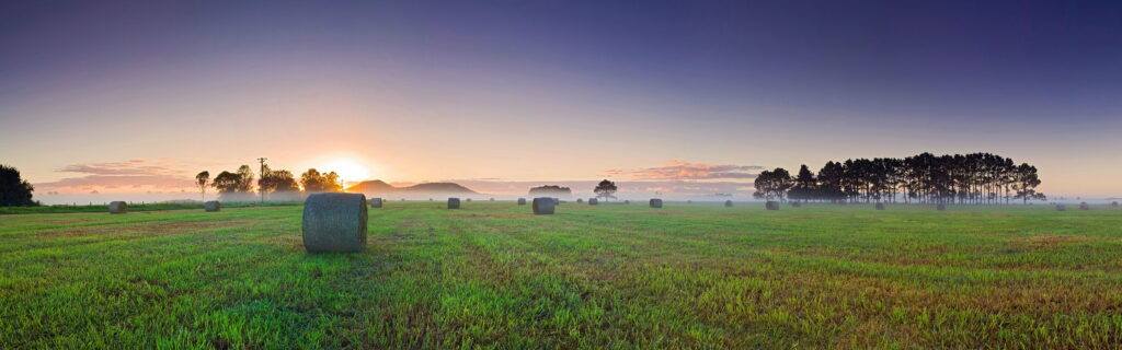 Mystical Haystacks Unveiled: Dual Monitor 4K Wallpaper of Enchanting Misty Landscape