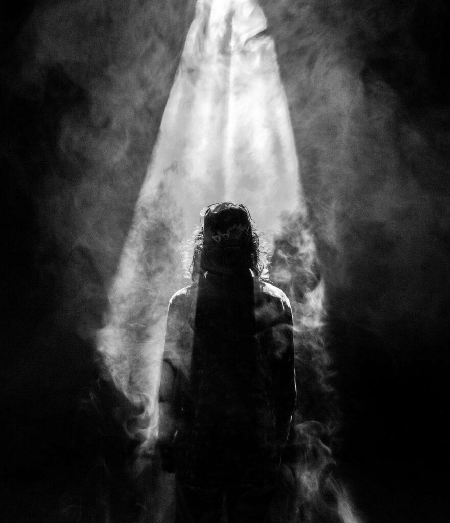 Divine Presence: Jesus Christ Silhouetted in Smokey Serenity - Inspirational Phone Wallpaper