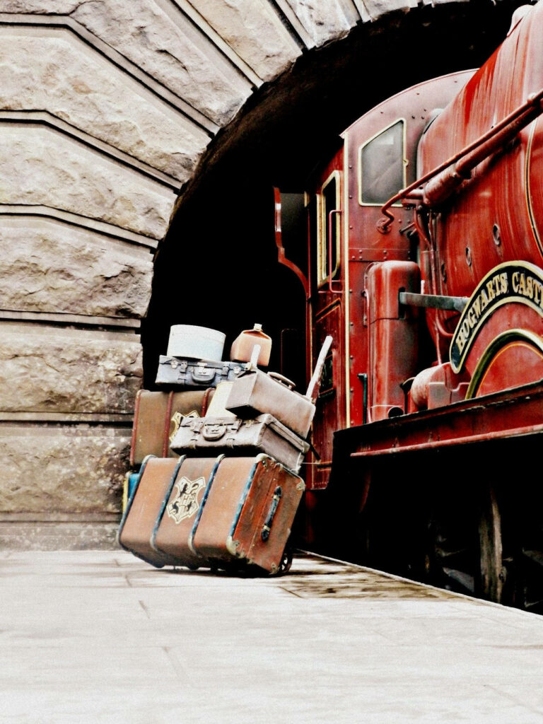 Mystical Suitcases: An Enchanting Backdrop of Harry Potter's Luggage amidst the Hogwarts Express Wallpaper