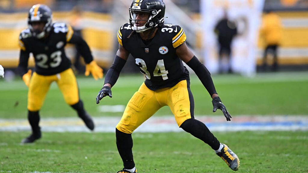 NFL player in black and gold uniform focused ready for action dynamic game day wallpaper background