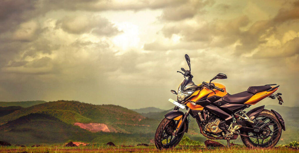 Vibrant NS 200 Motorcycle Wallpaper: Adventure Under Golden Sunlight