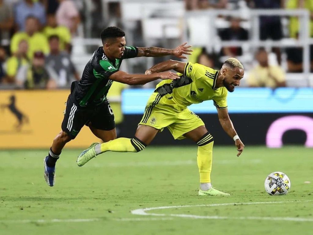 Hany Mukhtar of Nashville SC battles Austin FC defender in vibrant MLS soccer action wallpaper