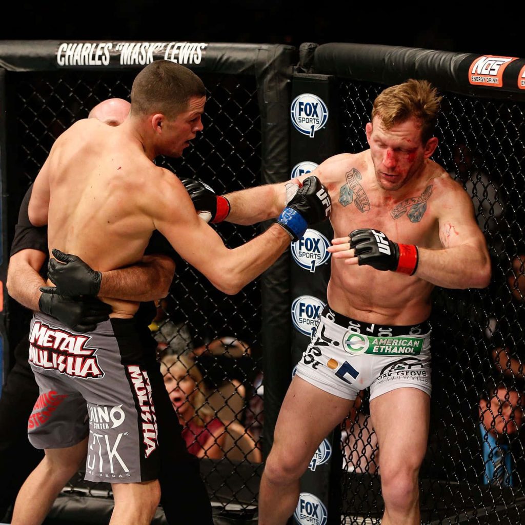 Nate Diaz delivers final blow to bloodied Gray Maynard in intense UFC Octagon fight moment Wallpaper