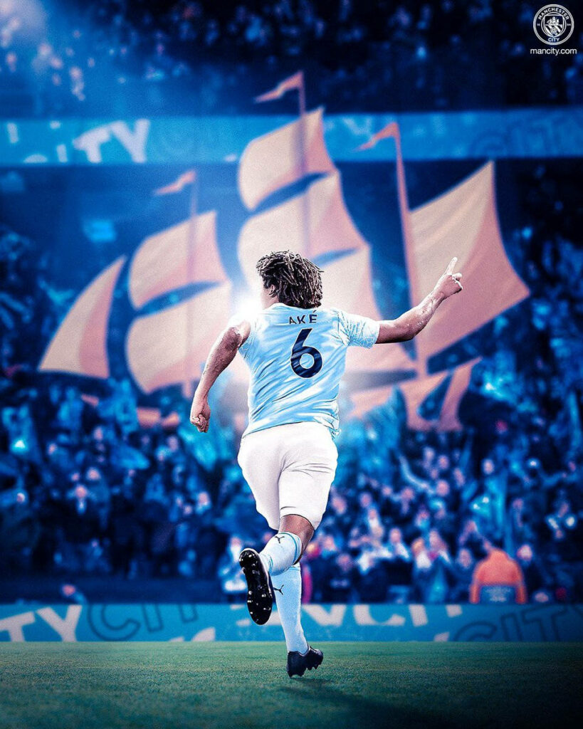 Nathan Ake in Manchester City Jersey 6: Energetic Wallpaper Background