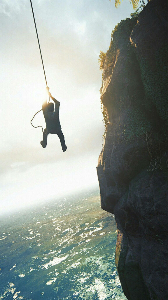 Dynamic Nathan Drake Wallpaper: Epic Adventure Against Ocean Cliffs