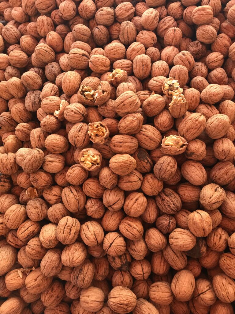 Natural Brown Walnut Wallpaper: Textured Design with Cracked Kernels