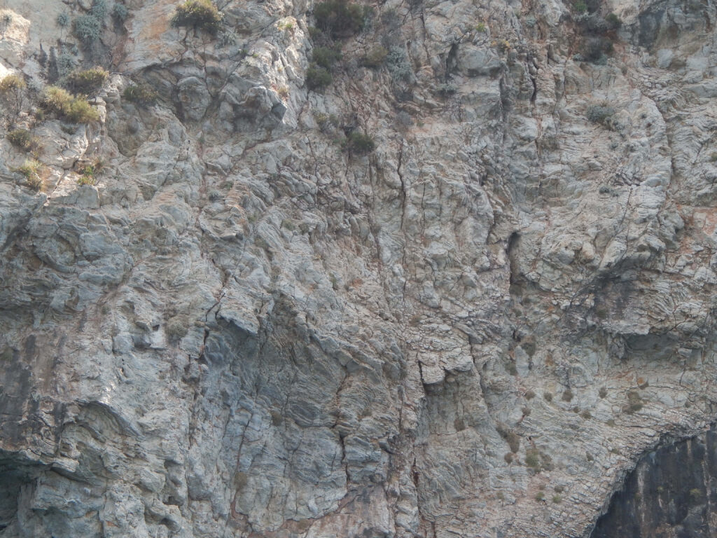 Close-Up of Rugged Rock Texture: Earthy Wallpaper Background