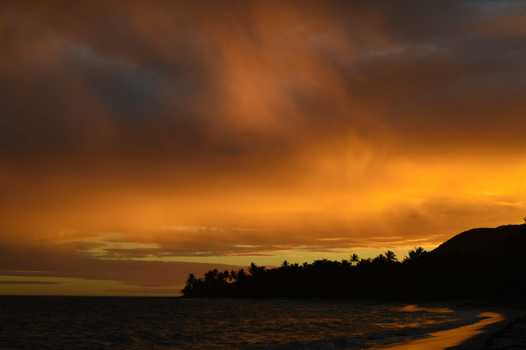 Alluring Guadeloupe: An Enchanting Sunset Painting the Sky in Radiant Orange Wallpaper