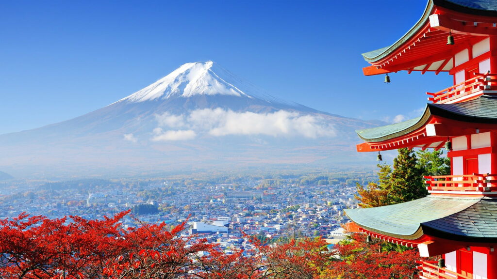 Mount Fuji with snow peak and red Chureito Pagoda framed by autumn leaves in Fujiyoshida Wallpaper