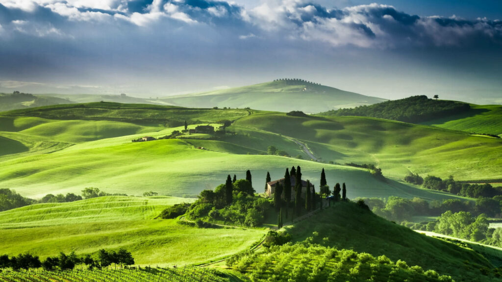 Nature's Splendor: A Captivating Vista of Tuscany's Luminescent Green Hill Wallpaper