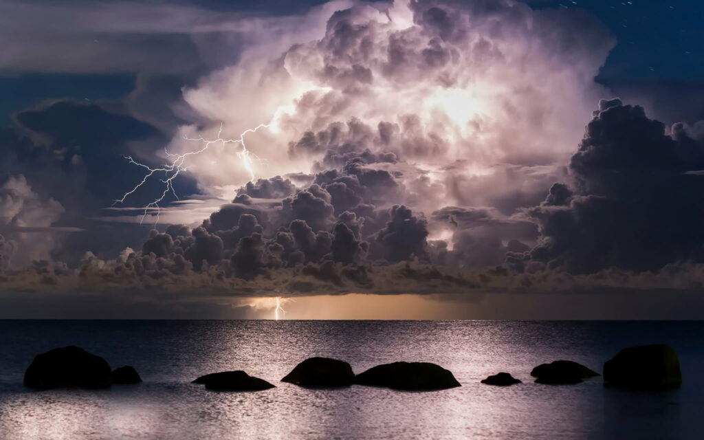 Majestic Tempest: Nature's HD Tapestry of Storm Clouds Sweeping Over the Ocean Wallpaper