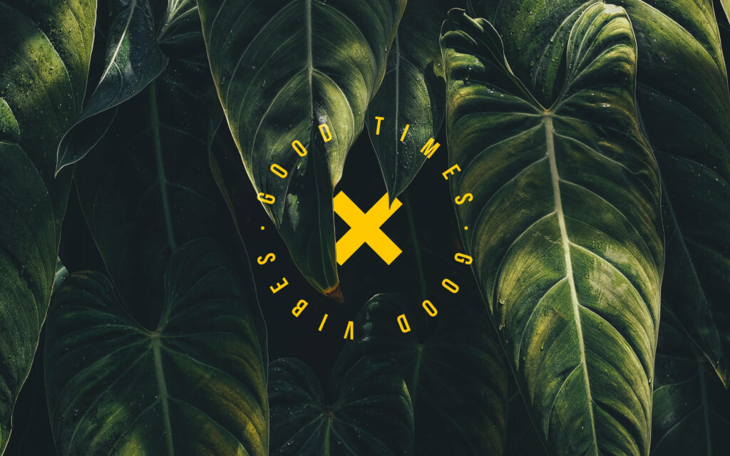 Serene Foliage Backdrop with Inspirational Quote: Good Times and Good Vibes Wallpaper