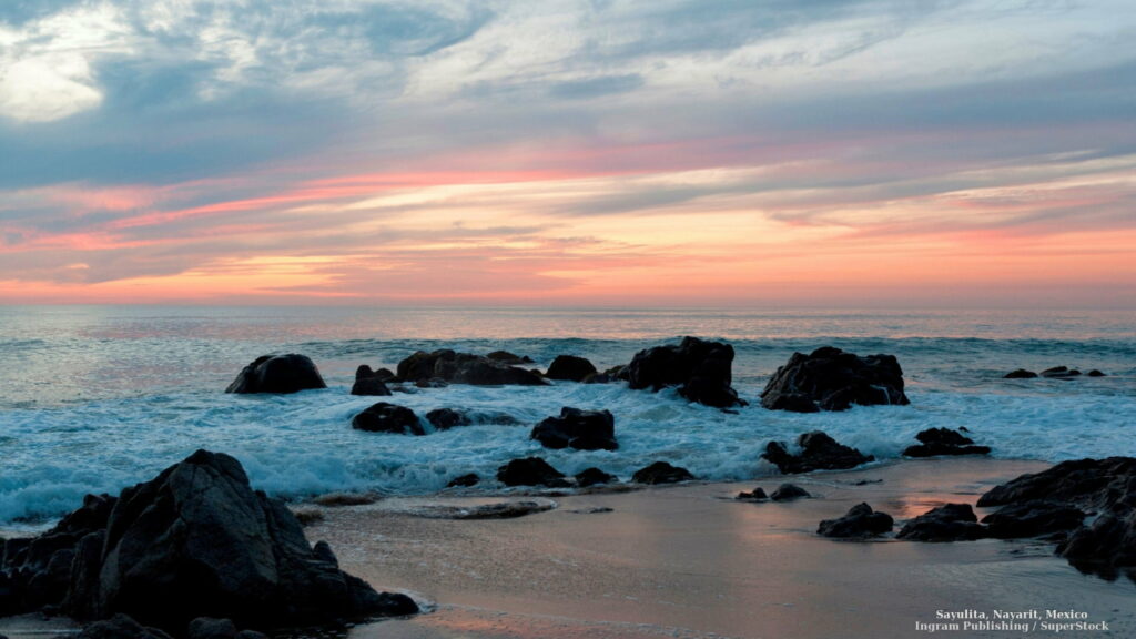 Serene Coastal Sunset: Majestic Waves and Rocky Shores in HD Wallpaper