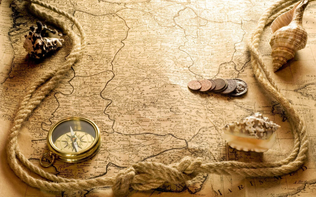 Nautical Nostalgia: A Vintage Laptop Backdrop Featuring a Map, Coins, Shells, Rope, and Compass Wallpaper