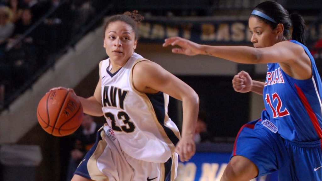 Navy Midshipmen basketball player driving past American University defender intense court action Wallpaper