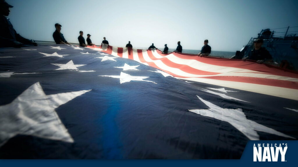 Proudly Unfurling the Stars and Stripes: Vibrant Navy Emblem Waves in Magnificent HD Wallpaper