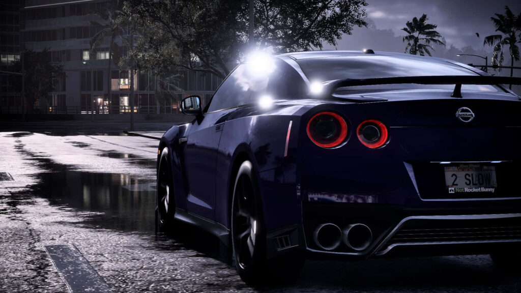 Sleek sports car racing through rain-soaked city streets at night Need For Speed Heat wallpaper
